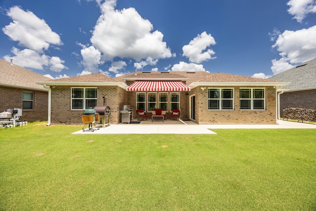 rear view of house featuring a patio area and a yard