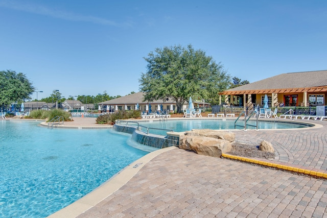 view of pool with a patio area and pool water feature