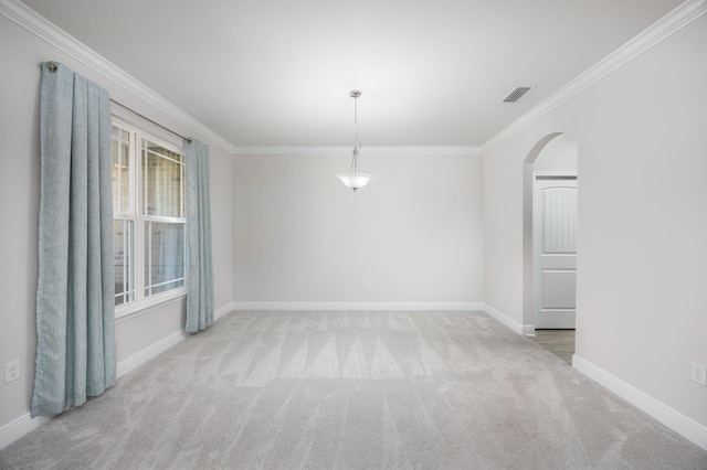 empty room with ornamental molding and light carpet