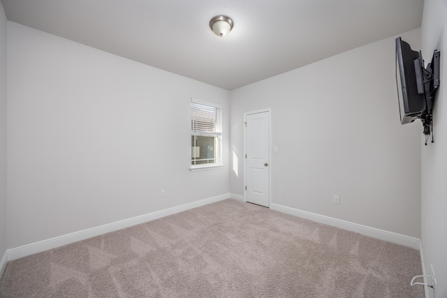 spare room with light carpet