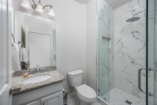 bathroom featuring walk in shower, vanity, and toilet