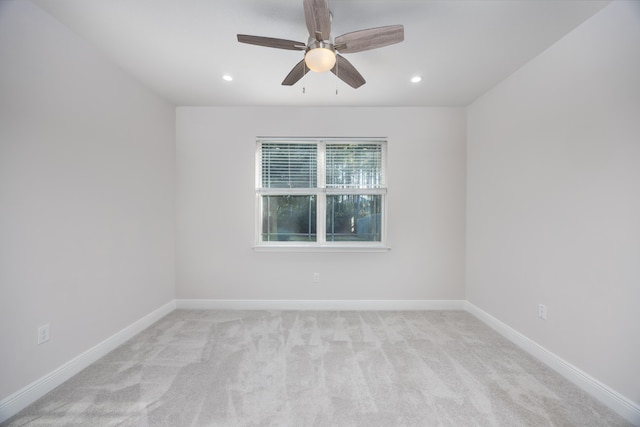 carpeted spare room with ceiling fan