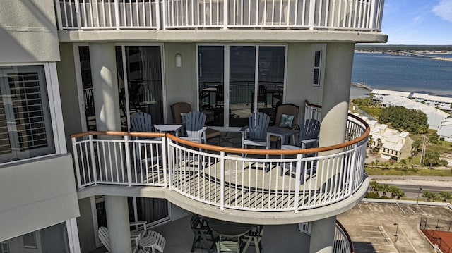 view of patio / terrace with a balcony and a water view