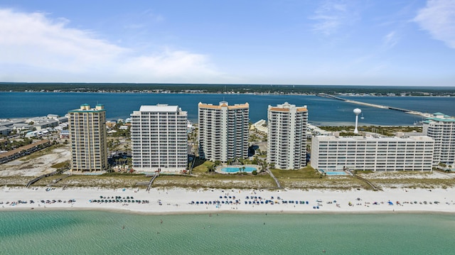 drone / aerial view featuring a beach view and a water view