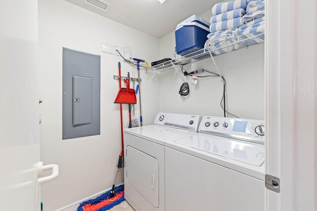 clothes washing area with visible vents, electric panel, laundry area, independent washer and dryer, and a textured ceiling