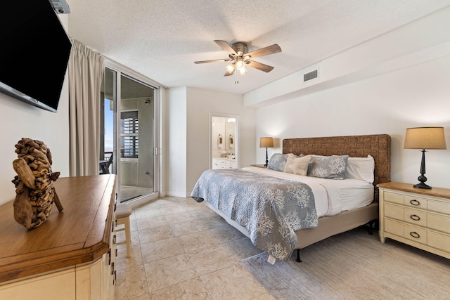 bedroom featuring visible vents, a textured ceiling, ceiling fan, and ensuite bathroom