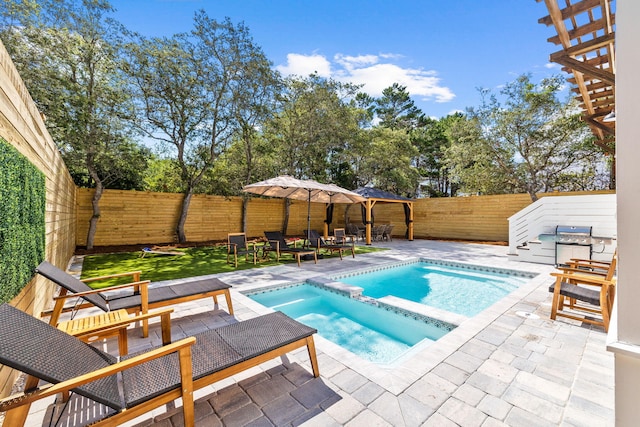 view of pool featuring an in ground hot tub and a patio area