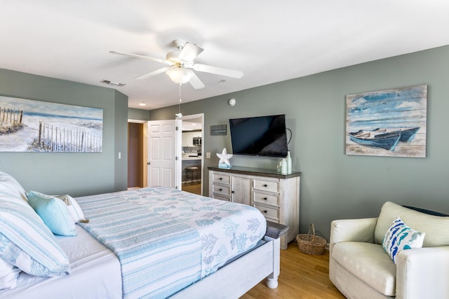 bedroom with a ceiling fan, light wood-type flooring, and visible vents