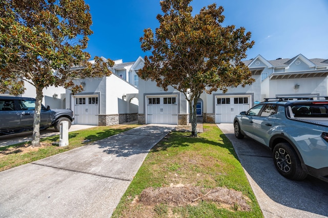 view of front of home featuring a garage and a front lawn