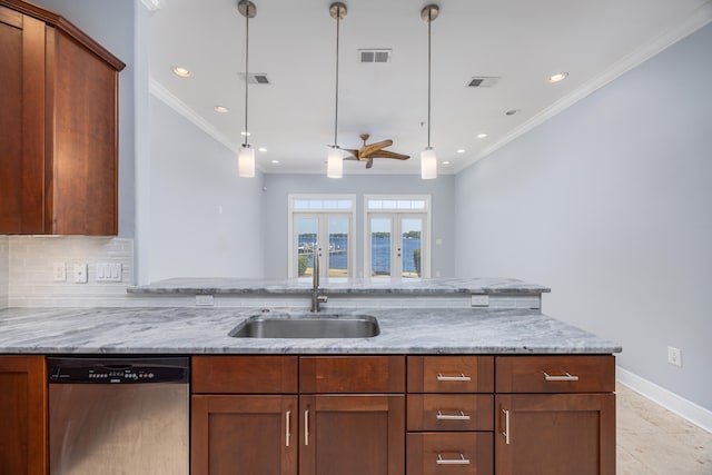 kitchen featuring sink, light stone countertops, dishwasher, light tile patterned floors, and pendant lighting