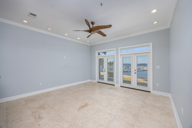 tiled spare room with ceiling fan, crown molding, and french doors