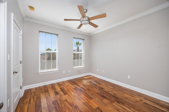 empty room featuring hardwood / wood-style flooring, ornamental molding, and ceiling fan