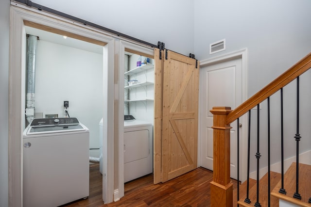 laundry area featuring washer hookup, dark hardwood / wood-style flooring, and a barn door