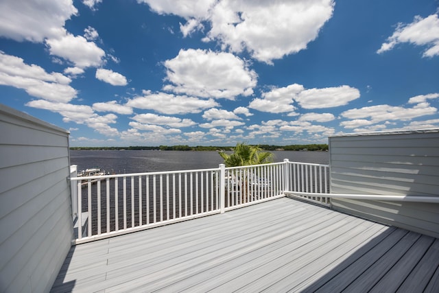 wooden terrace featuring a water view