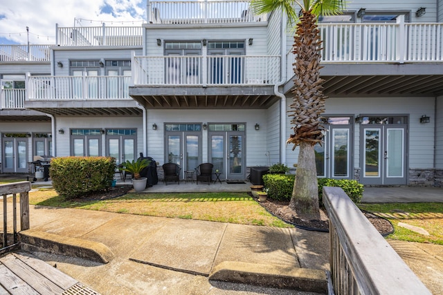 rear view of property with a patio and a balcony