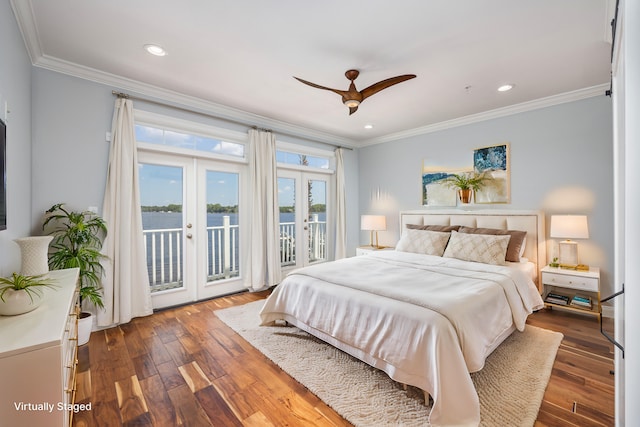 bedroom featuring french doors, access to exterior, a water view, ornamental molding, and dark wood-type flooring