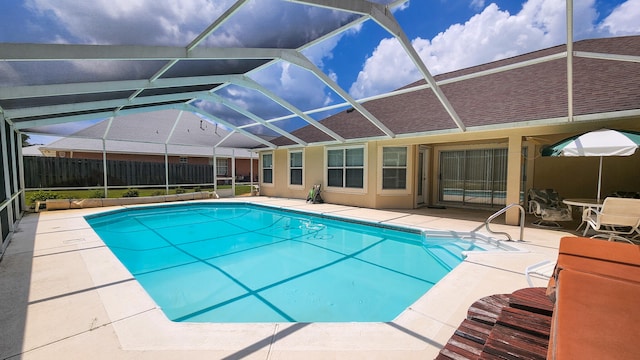 view of swimming pool with a patio and glass enclosure