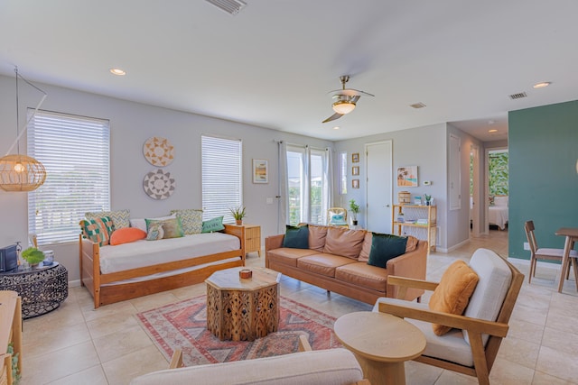 living room featuring ceiling fan and light tile patterned floors