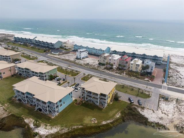 drone / aerial view with a water view and a beach view