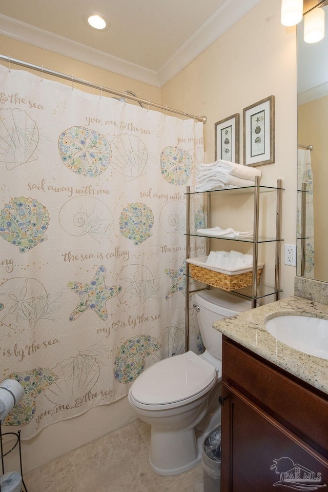 bathroom with crown molding, vanity, and toilet