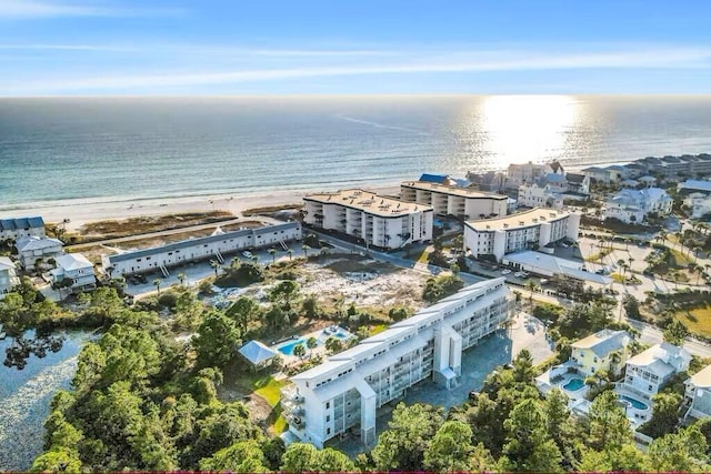 aerial view with a water view and a beach view