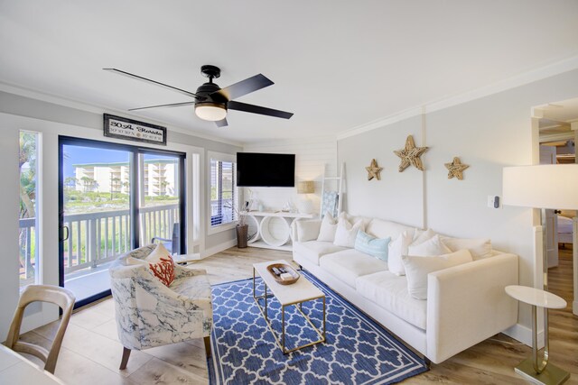 living room featuring light hardwood / wood-style flooring, crown molding, and ceiling fan