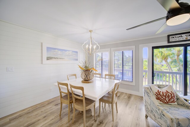 dining room with a notable chandelier, ornamental molding, and light hardwood / wood-style floors