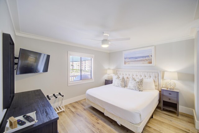 bedroom with ceiling fan, light wood-type flooring, and crown molding