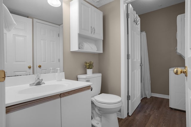 full bathroom with baseboards, toilet, wood finished floors, a textured ceiling, and vanity