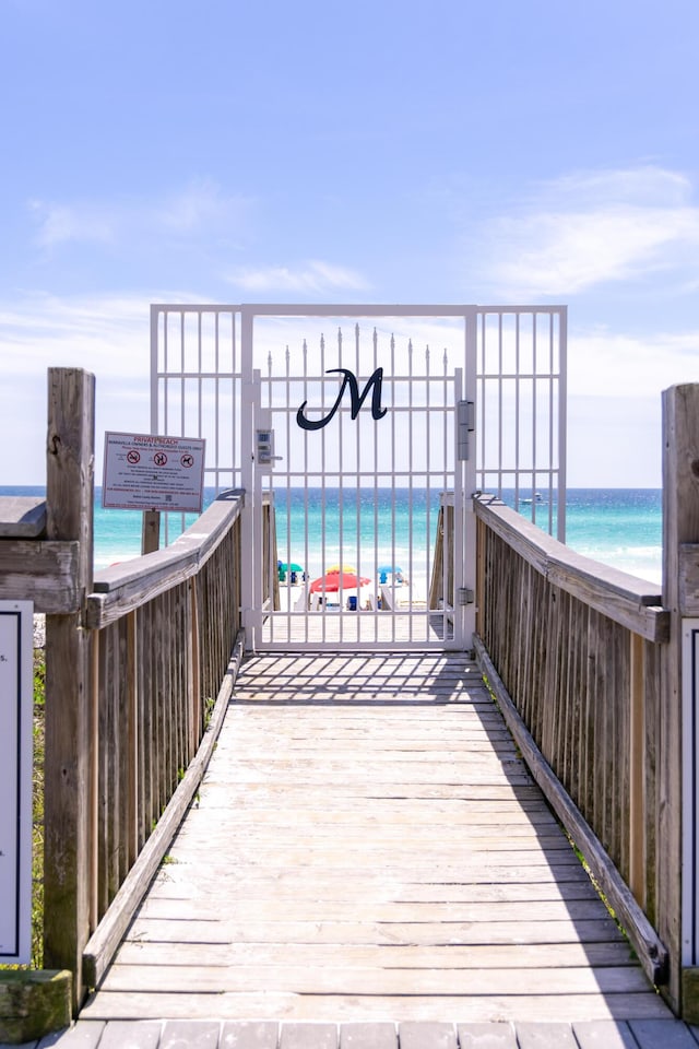 wooden deck with a view of the beach and a water view