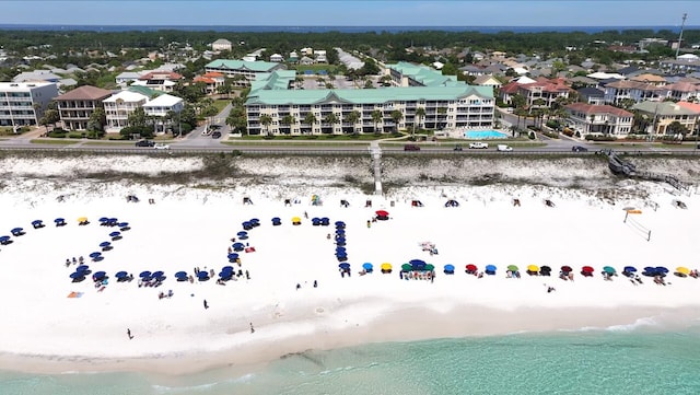 drone / aerial view with a water view and a view of the beach