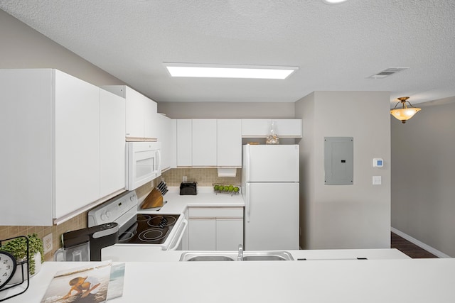 kitchen featuring white appliances, electric panel, white cabinetry, and light countertops