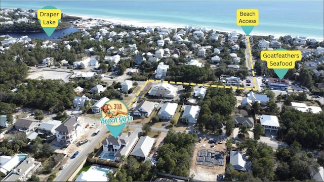 bird's eye view with a water view and a beach view