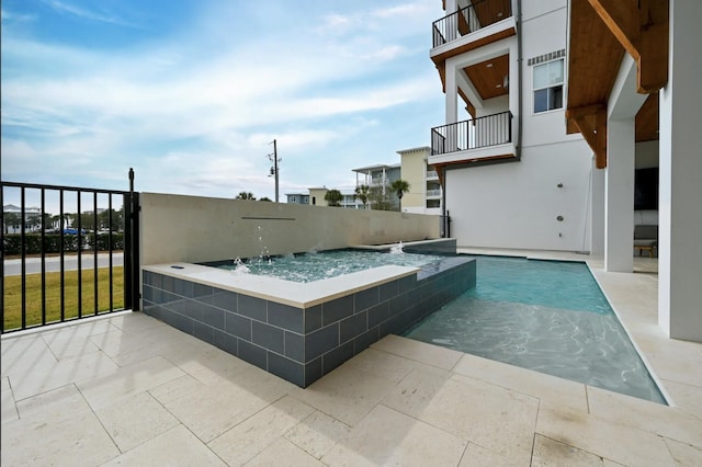 view of pool with pool water feature and a jacuzzi