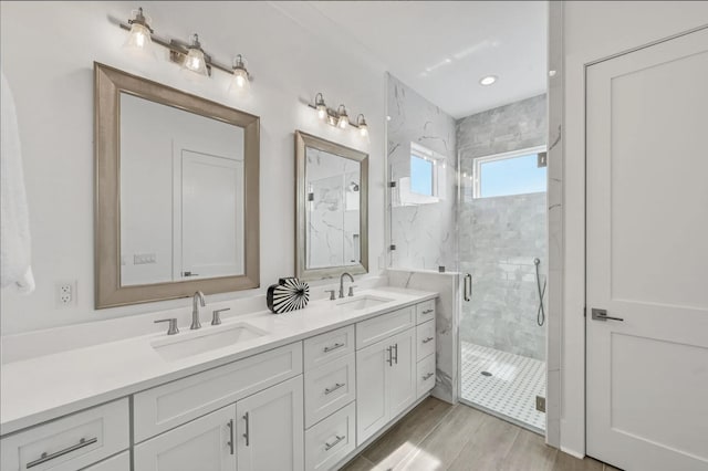 bathroom featuring vanity, hardwood / wood-style flooring, and walk in shower