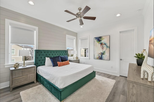 bedroom with ceiling fan and hardwood / wood-style floors