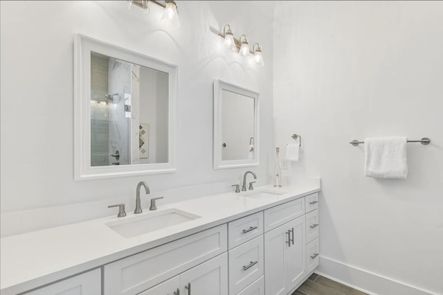 bathroom featuring vanity, wood-type flooring, and walk in shower