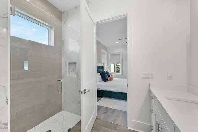 bathroom featuring vanity and a shower with shower door