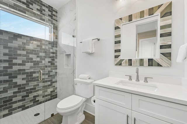 bathroom with vanity, toilet, and walk in shower