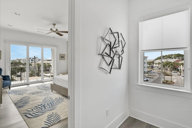 bedroom with hardwood / wood-style floors and access to outside