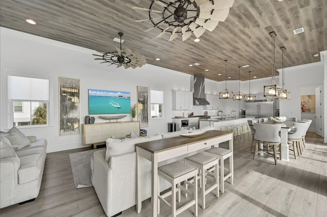 living room featuring wooden ceiling, ceiling fan, and light hardwood / wood-style flooring