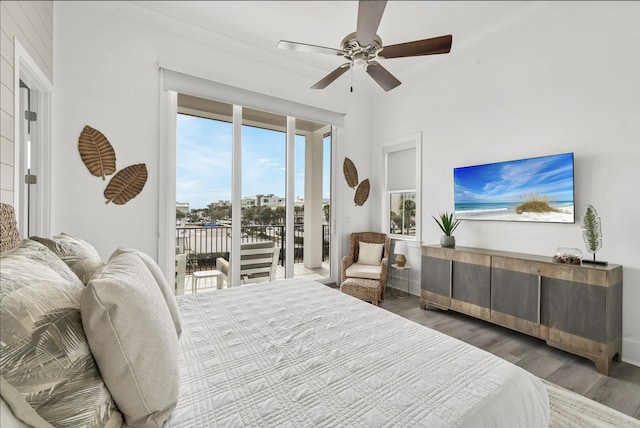 bedroom with dark wood-type flooring, ceiling fan, and access to outside