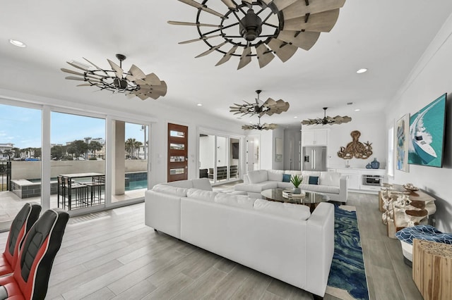 living room featuring light hardwood / wood-style floors and ceiling fan