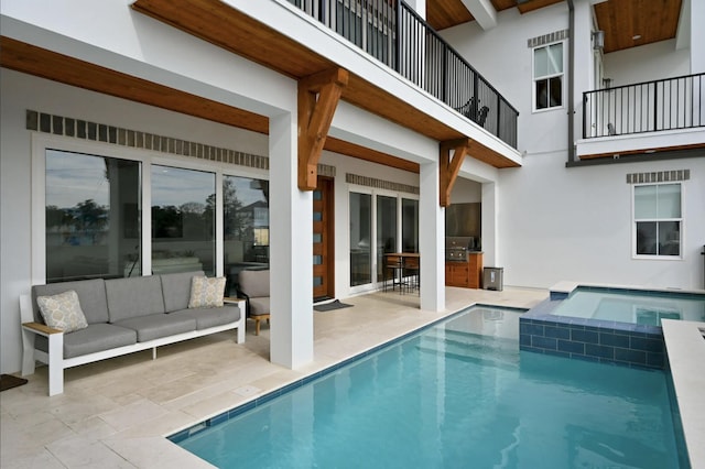 view of swimming pool with an in ground hot tub, a grill, an outdoor hangout area, exterior kitchen, and a patio