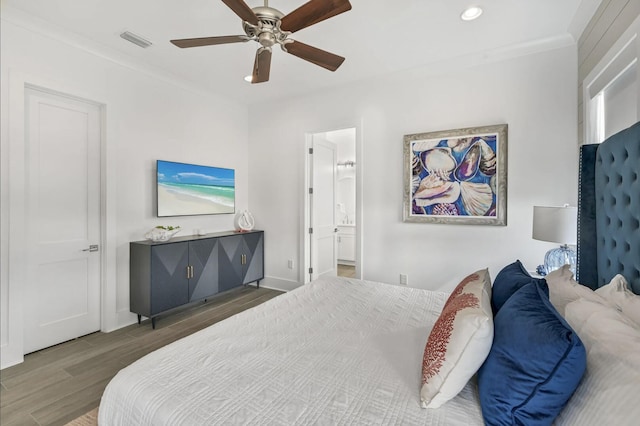 bedroom featuring ceiling fan, ornamental molding, dark hardwood / wood-style flooring, and ensuite bathroom