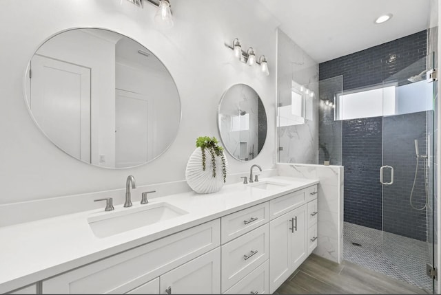 bathroom featuring vanity and an enclosed shower