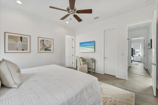 bedroom with ceiling fan and light hardwood / wood-style flooring