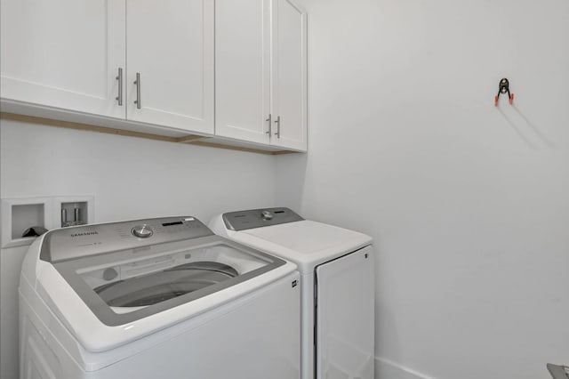 laundry area featuring cabinets and washing machine and clothes dryer