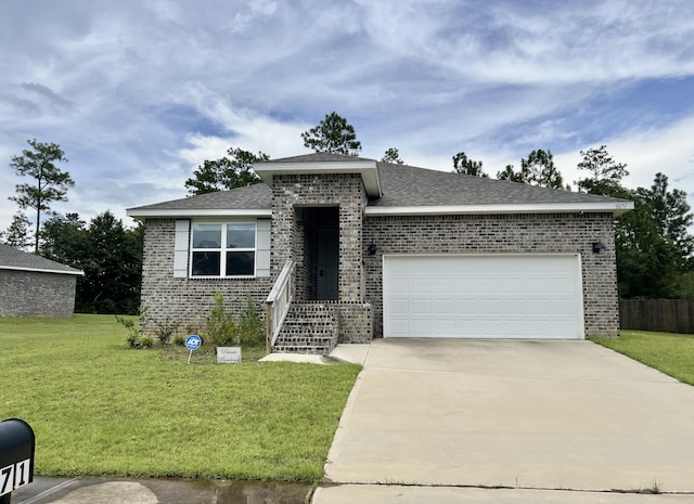 view of front facade featuring a garage, driveway, brick siding, and a front yard