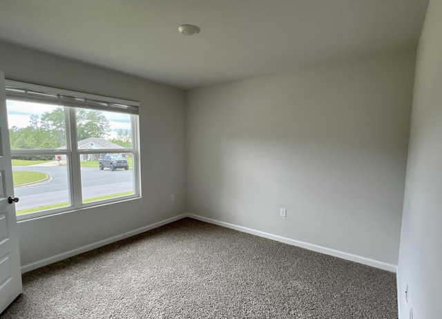 spare room with carpet flooring and baseboards